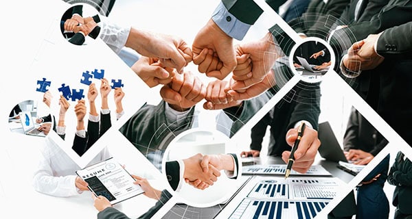 People shaking hands, fist pumping and holding puzzle pieces